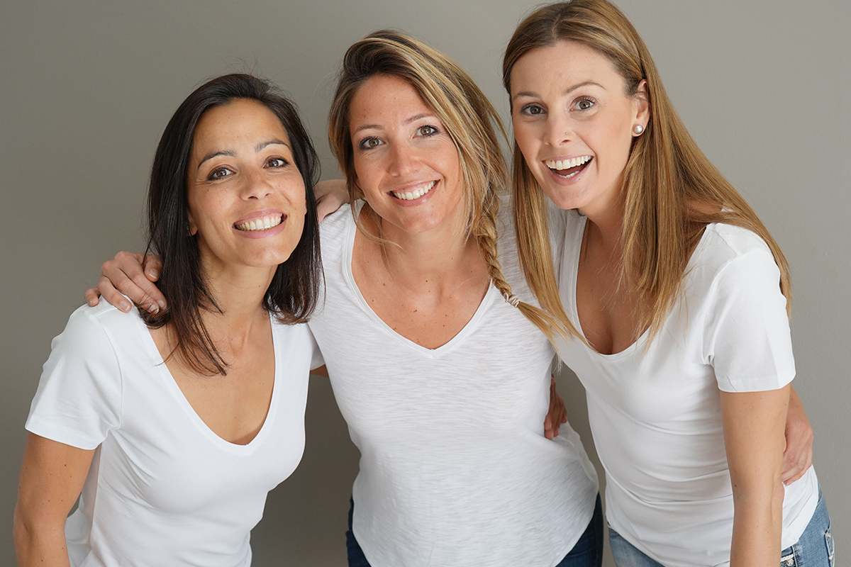 attractive women with white shirt standing on grey wall attractive women with white shirt standing on grey wall