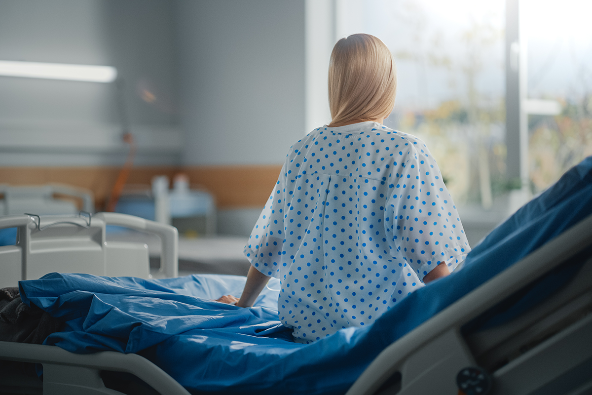 beautiful caucasian female patient sitting on a bed beautiful caucasian female patient sitting on a bed