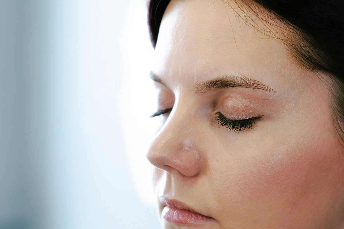 close up face of woman brunette looking down