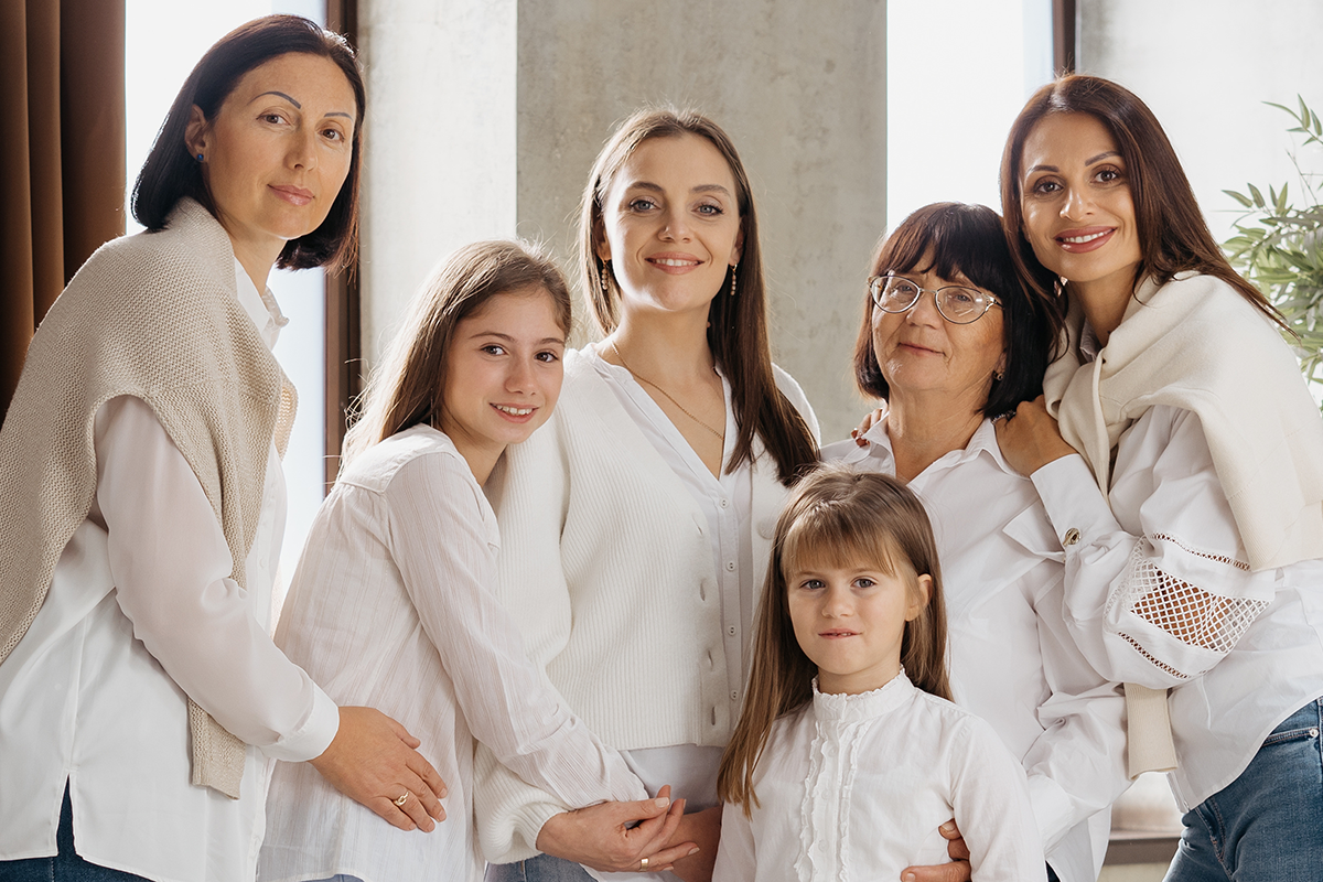 delighted cute young girls, their moms and grandmother smiling delighted cute young girls, their moms and grandmother smiling