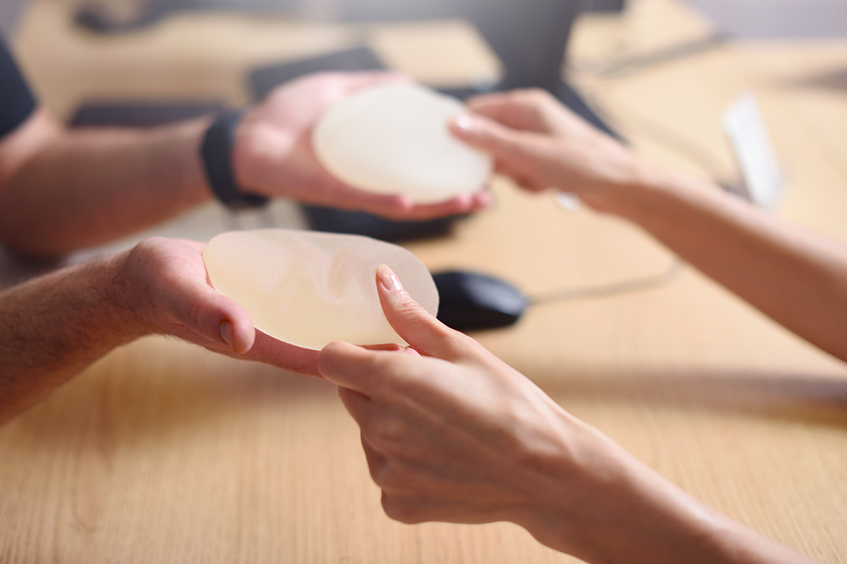 doctor offers breast augmentation implants to a woman