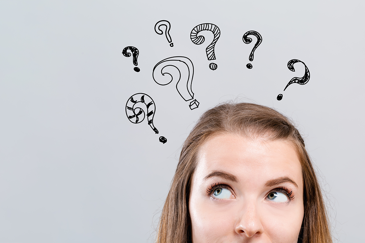 hand draw question marks with young woman looking upwards hand draw question marks with young woman looking upwards