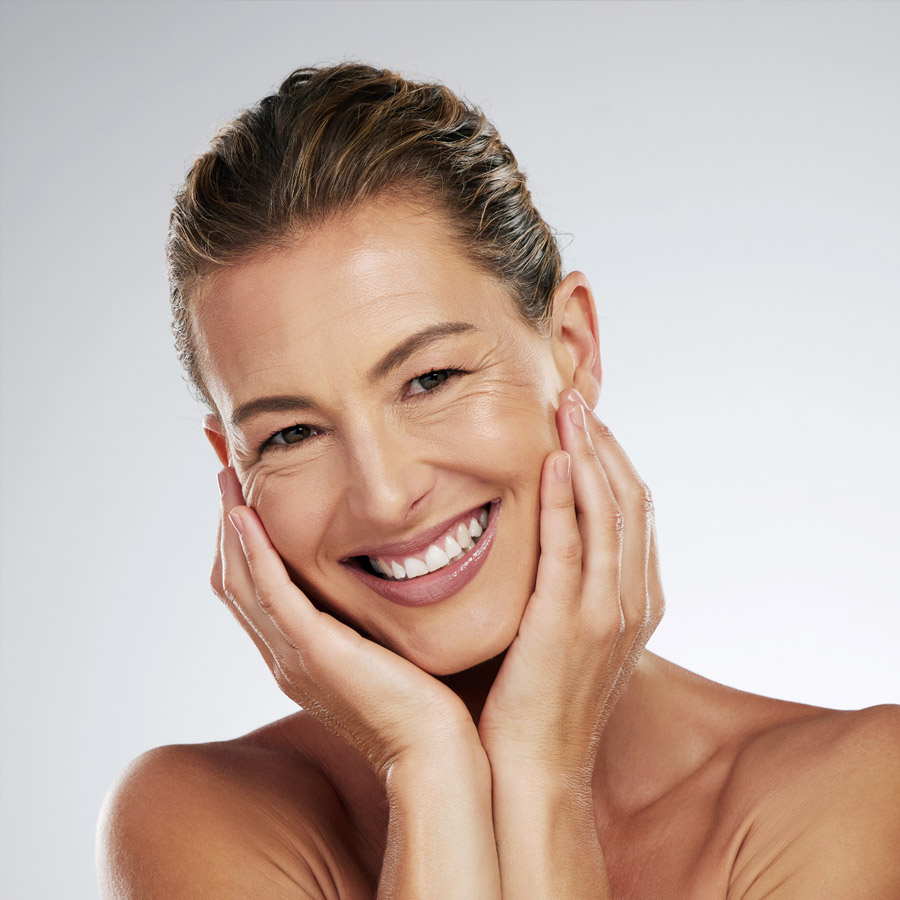 Skincare, face beauty and mature woman with smile for facial wellness against a grey mockup studio background.