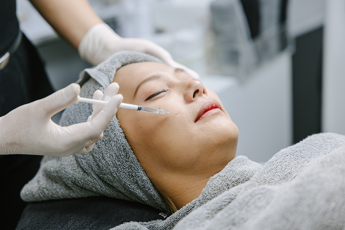 skin doctor injecting filler at woman face skin for facial treatment