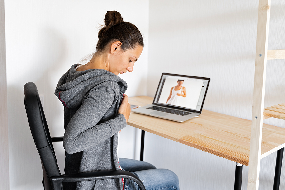 woman doing self breast check up by online tutorial